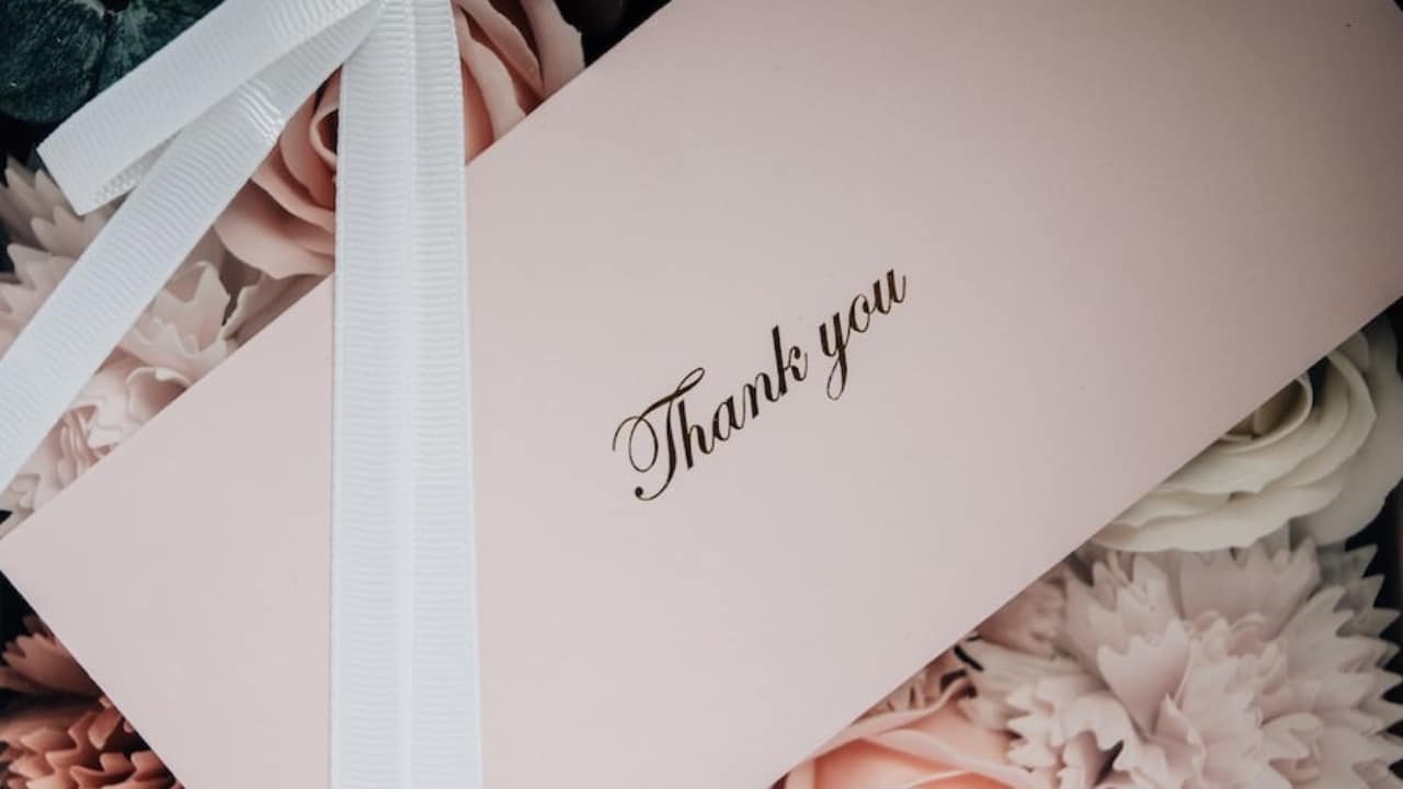 White thank you letter on a bed of flowers